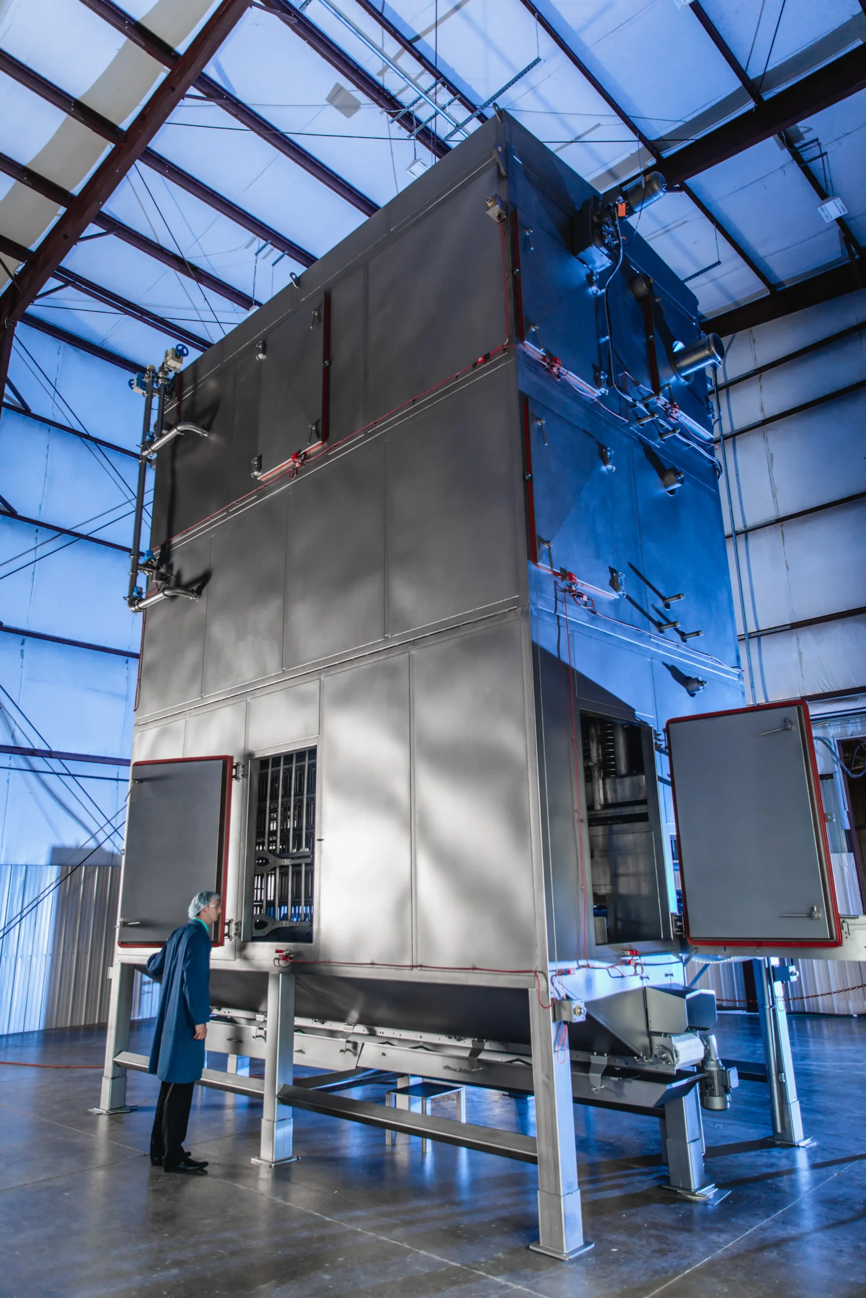 CircFood Vertical Cruster with an employee standing beside it